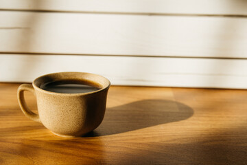a cup of coffee on the parquet floor
