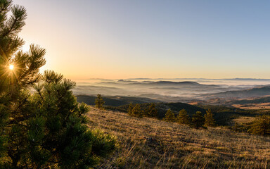 sunrise over the mountains with mist visible in valeys