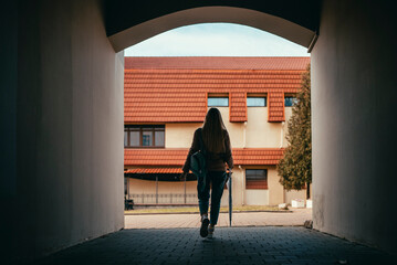 the silhouette of a girl walks through the tunnel from the arch of the house