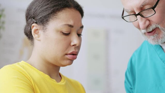 Closeup of physiatrist fixing cast to patient's hand, injury treatment, recovery