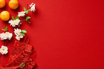 Happy Chinese New Year flat lay composition. Red envelope packets, orange mandarins, Chinese...
