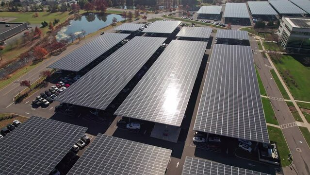 Rows of solar panels on the roof of cars and parking lot structures absorbing green energy