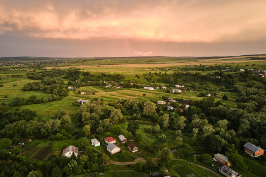 Aerial view of residential houses in suburban rural area at sunset