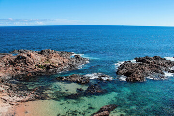 See the coastline of Salvador da Bahia, Brazil, showing the beach at porto da barra and historic landmarks and fort of santa maria during the summer.