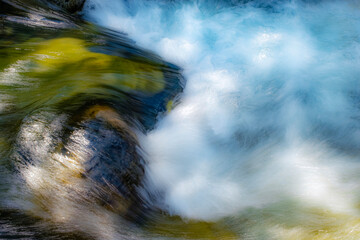 long exposure abstract image of whirlpool water in a mountain river of crystal clear water, green,...
