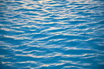Closeup seascape surface of blue sea water with small ripple waves