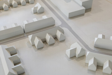 Top view of white architectural models. Architect's design thinking process. Urban planning model. Architecture studio working area on table.
