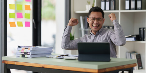 Obraz premium Pleasant positive businessman using digital tablet at home office