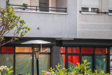 Close up on the burner head of a patio heater, used to heat and keep warm the outdoor and exterior part of catering facilities such as restaurances, cafes and bars for their terraces. ...