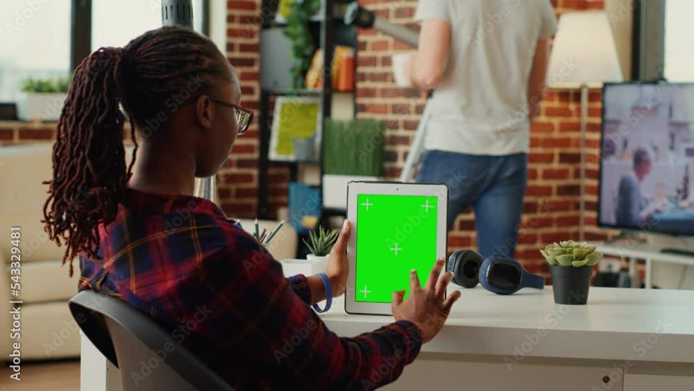 Poster office employee analyzing digital tablet with greenscreen display, working with chroma key template 