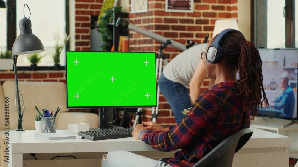 Poster office worker analyzing greenscreen template on monitor, working with isolated mock up background at