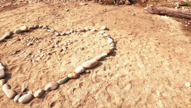 Love shape with peebles next to river in Punakha, Bhutan