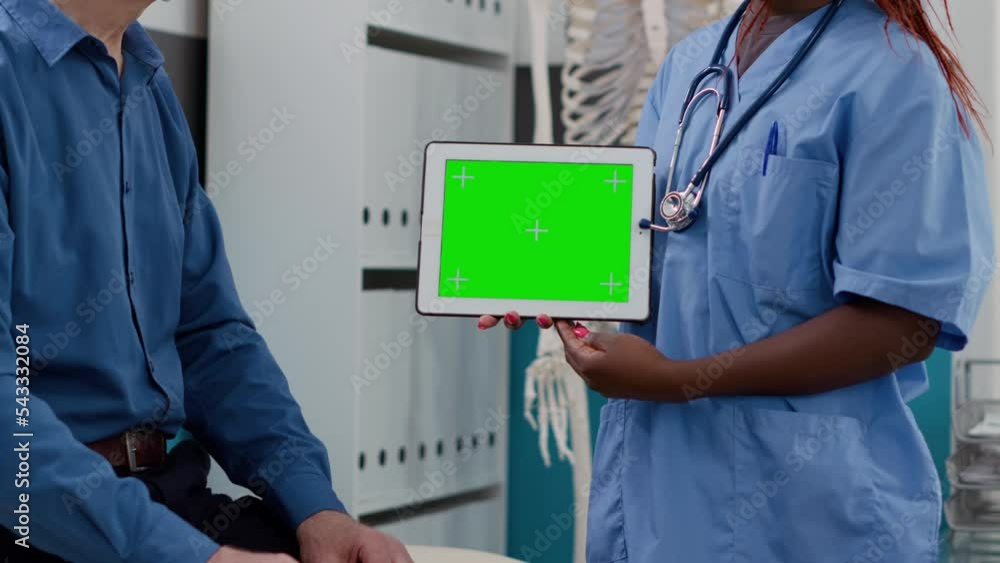 Poster specialist holding horizontal greenscreen on tablet at checkup with elderly patient. using blank moc