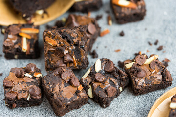 Homemade dark chocolate brownies topping with almonds slices and chocolate chips