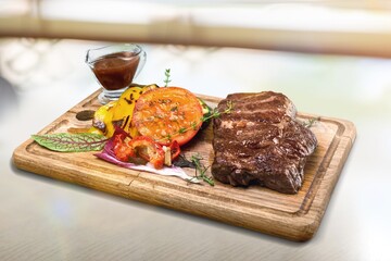 Grilled meat mix plate and vegetables on the desk