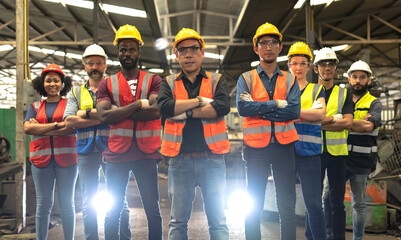 Naklejka premium Photo group of factory workers teamwork standing with armcressed in industrial factory, Engineer Concept