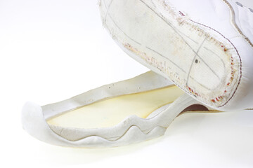 Image of white sneakers with peeling soles.