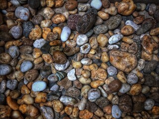 Smooth round pebbles gravel small stone texture for background.