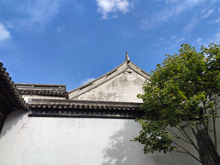 Fototapeta na wymiar Chinese ancient architect with white wall under blue sky in sunny afternoon
