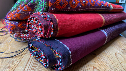 Pile of colorful handmade woven fabric of Batak. Traditional ethnic fabric of Indonesia