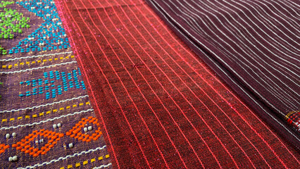 Pile of colorful handmade woven fabric of Batak. Traditional ethnic fabric of Indonesia