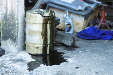 black engine oil flows from the tank to the ground
