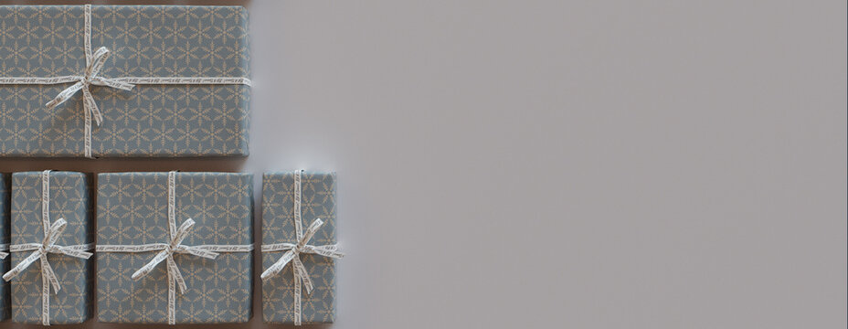 Modern Duck Egg Blue and White Christmas Wallpaper with copy-space. Neatly arranged Festive Gifts form a Grid pattern. 