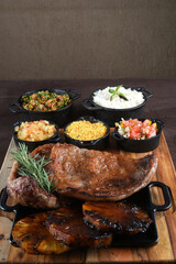 barbecued meat with cassava fried banana rice beans and herb sauce, typical brazilian food