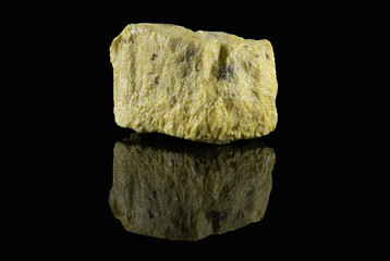 A faceted shard of sulfur, a yellow mineral