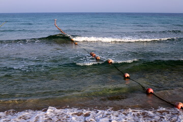 Hemp rope with buoys on the city beach