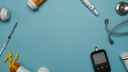 Top view of a glucose meter on blue background. World diabetes day, Medicine, diabetes and health...