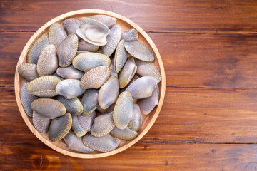Striped Clam or Clam bivalve molluscs  on wooden background for seafood dish.