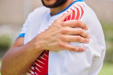 Sports, soccer and hands of man with shoulder pain from training game, soccer field accident or...