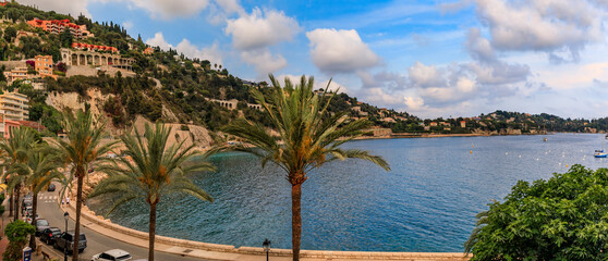 Villefranche sur Mer medieval town in South of France, palm trees along the bay