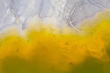 Aerial drone view of a huge decanting lake. Background of green residuals from a copper mine