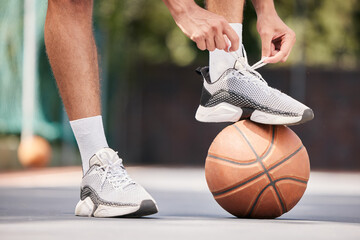 Tie shoes, sports and hands on a basketball court getting ready for training, cardio workout and fitness exercise. Footwear, sneakers and healthy athlete in preparation for a practice game or match