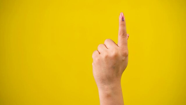 Indian Voter Hand with voting sign or ink on yellow background with copy space.