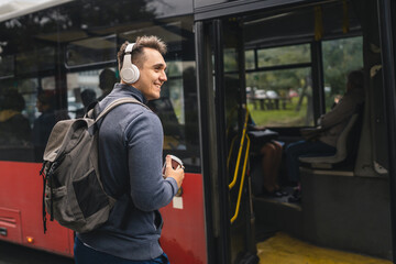One man young adult male tourist at public transport bus station