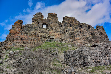 Fototapeta na wymiar Fortress in the clouds, Amberd, a 7th-century fortress located on the slopes of mount Aragats at the confluence of the Arkashen and Amberd rivers in Aragatsotn province, may 3, 2019, Armenia.