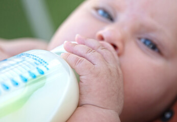 Baby drinking her bottle of milk