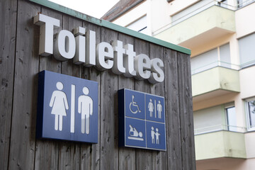 toilettes french text means wc Toilet sign icon on wooden building facade water-closets wall...