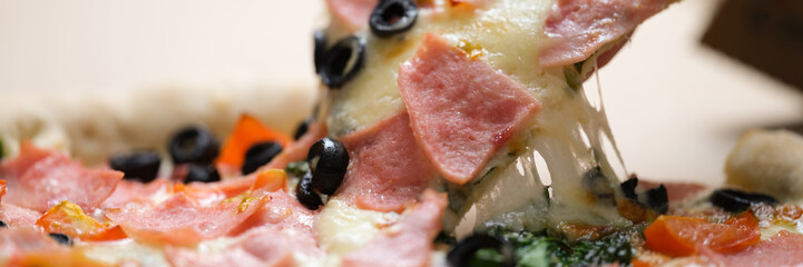Tasting delicious pizza slices with tomato garlic and sausage