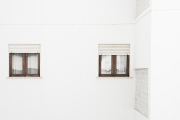 Two windows on white building