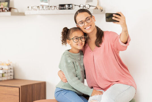 Mother, girl and phone selfie at optometrist, glasses and smile for eye vision, eyesight and social media picture for new lense frame. Woman, child and happy with eyeglasses or 5g mobile smartphone