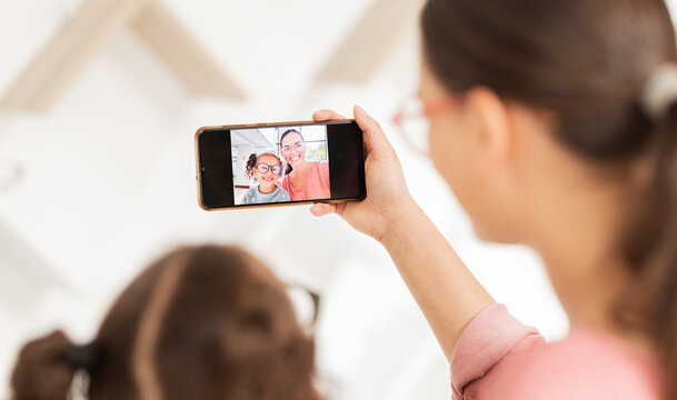 Family phone selfie, mother and girl at optometry hospital taking picture for happy memory together. Love, care and 5g mobile photo of mom bonding with kid for social media, online or internet post.