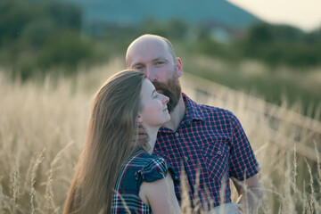 Young couple in love in the summer field