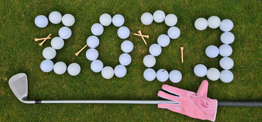 Golf 2023 New Year number with golf ball on grass field relief of a sports club