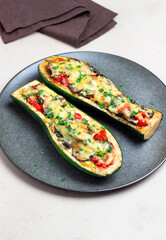 Zucchini stuffed with mushrooms, tomatoes and cheese. Healthy eating. Vegetarian food. Diet.