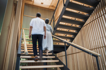 階段を上る日本人シニア夫婦