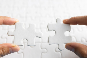 Closeup hand of man connecting jigsaw puzzle with sunlight effect, Business solutions, success and strategy concept